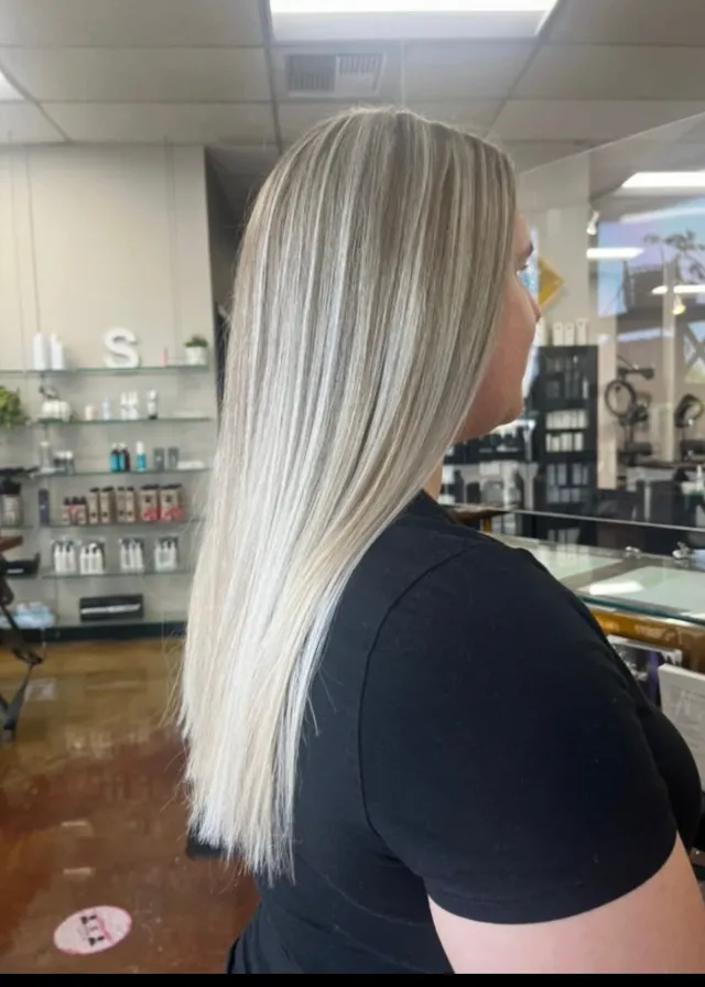 Bright icy platinum blonde hair in a straight shoulder-length lob.