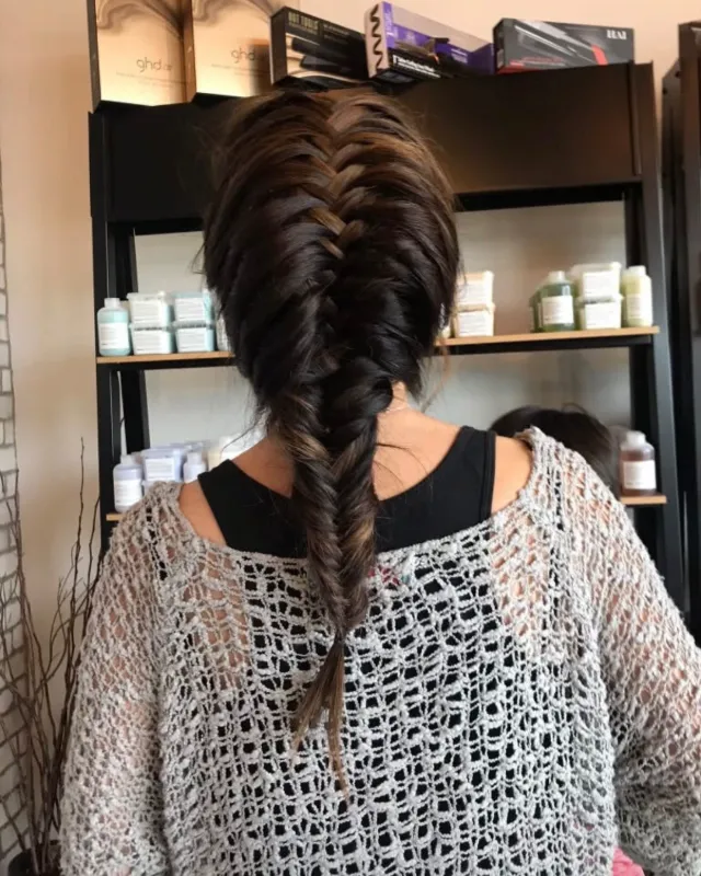 A large pull-through-style braid down the back of the head.