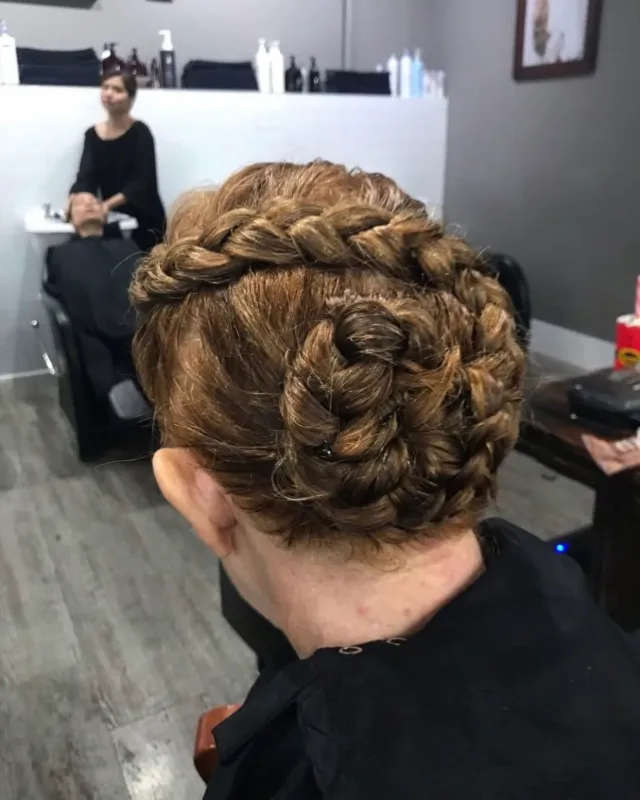 Detailed updo built from braided rosettes.