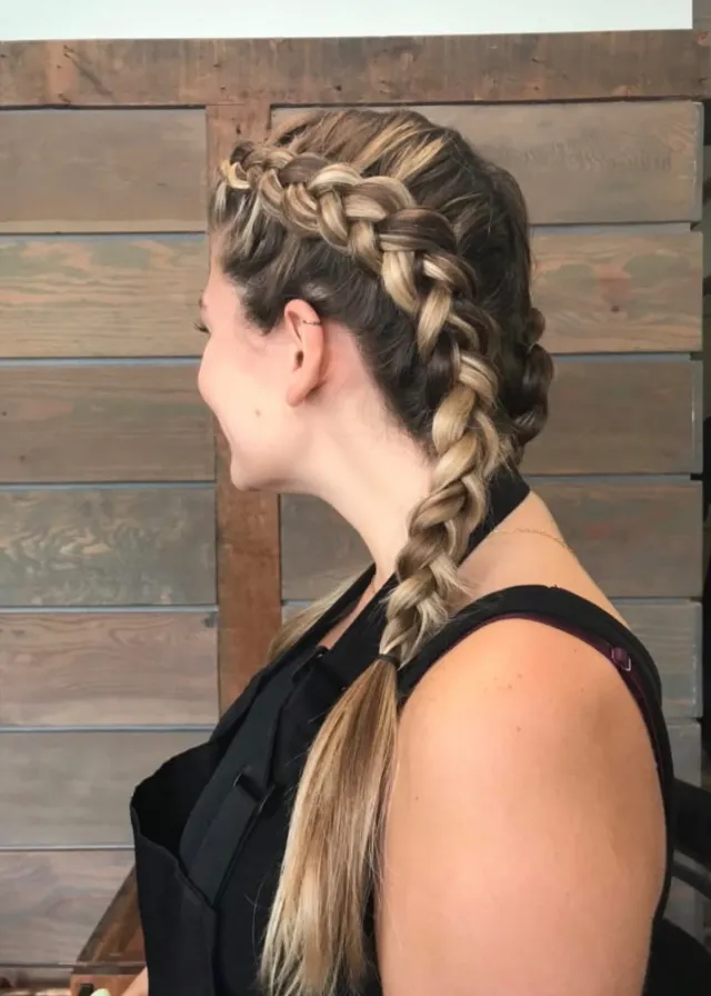Two large braids on dimensional blonde hair, shown in profile.