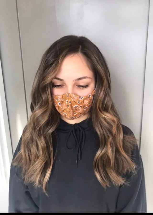 Brunette hair with soft caramel blended highlights.