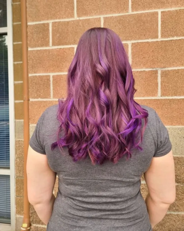 Purple full-color result on long wavy hair, shown from the back.