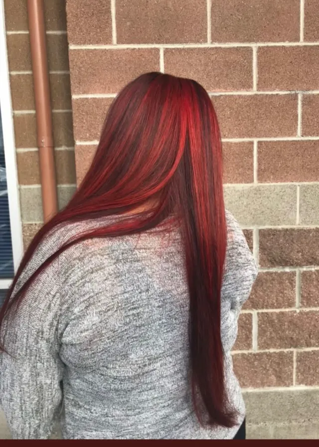 Long red hair with darker depth and bright red dimensional ribbons.